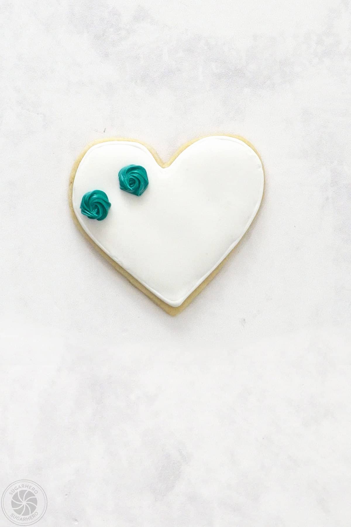 A Valentine's Day Sugar Cookie with 2 stiff piped rosettes.