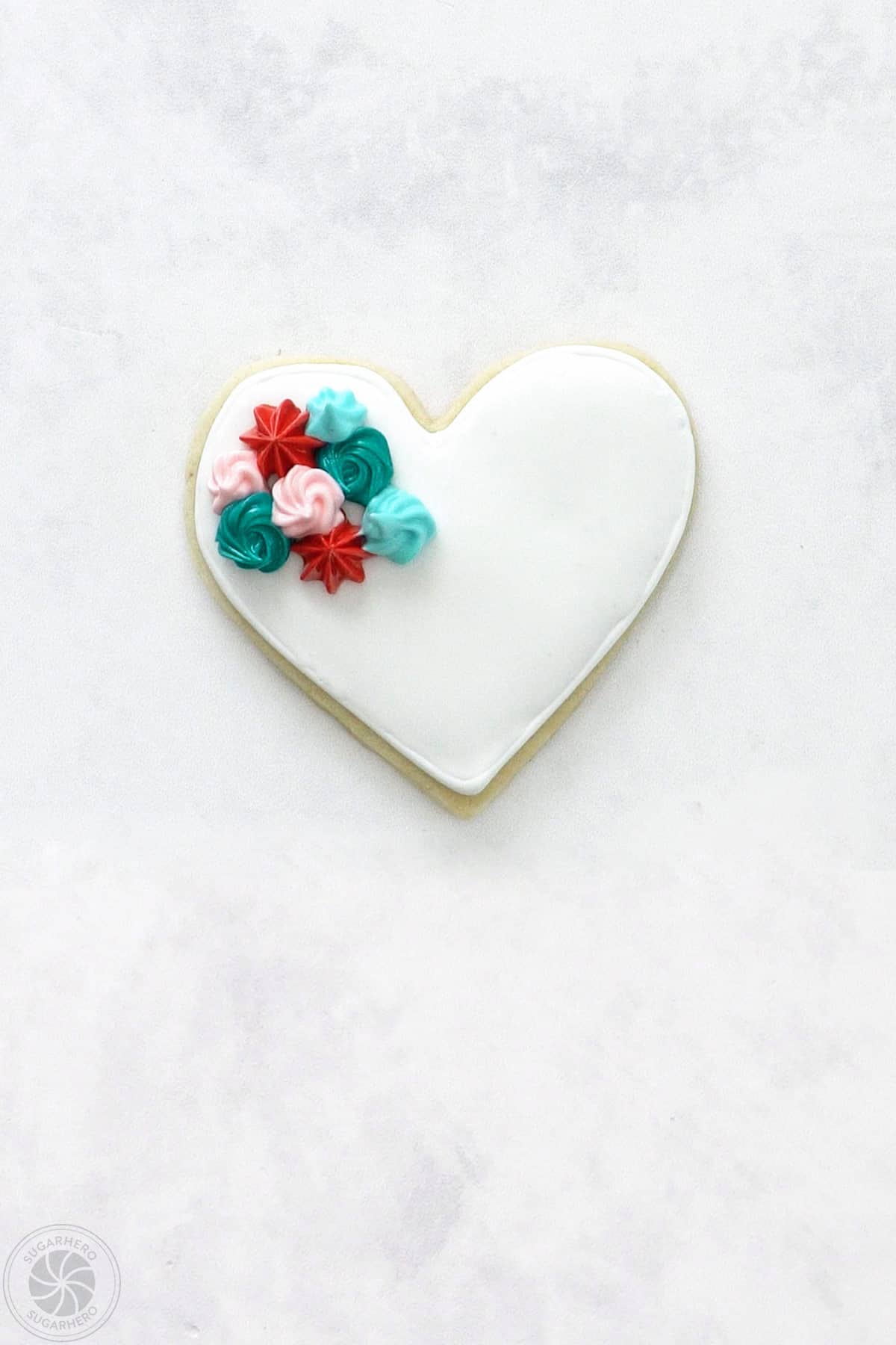 A Valentine's Day Sugar Cookie with an assortment of colorful stiff piped rosettes.