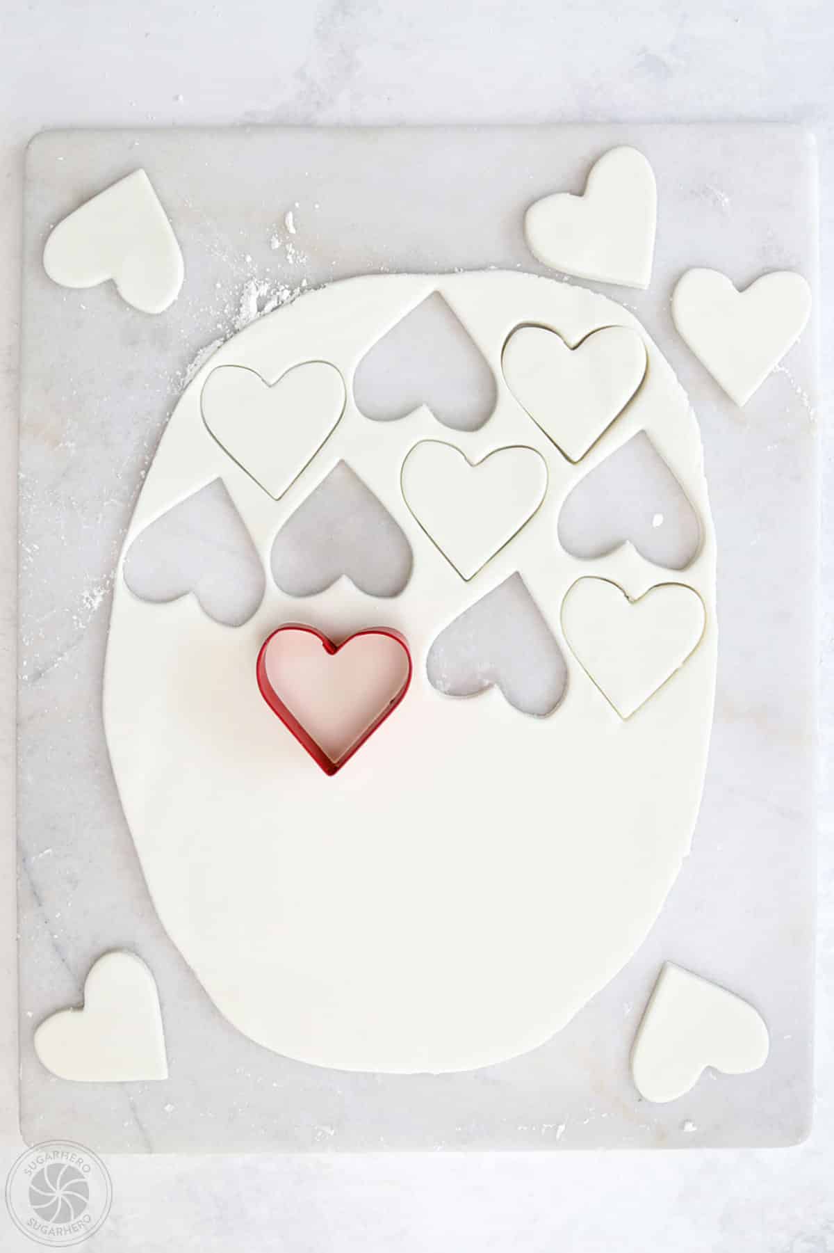 Rolled out fondant being cut into hearts.