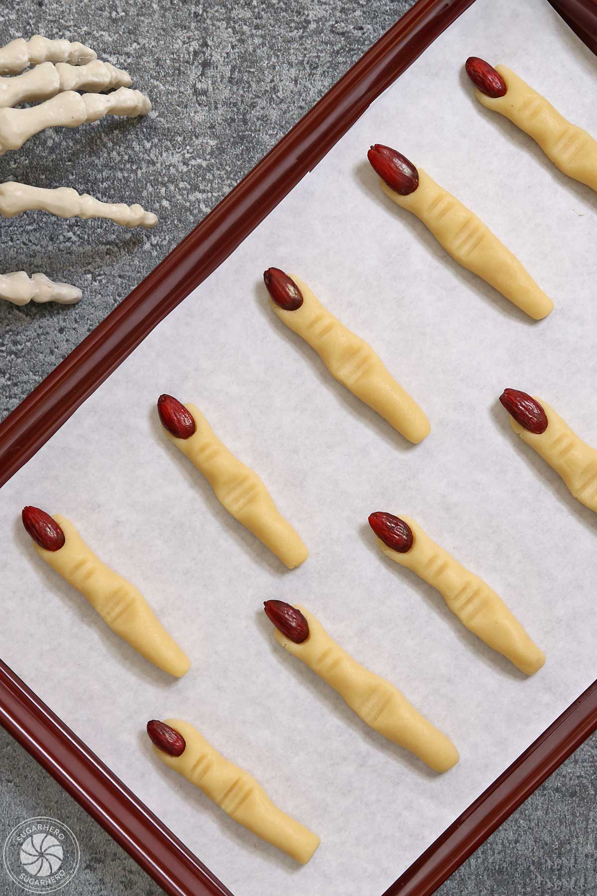 Witch Finger cookies on a parchment-lined baking sheet.
